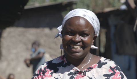 Wanja is delighted at the opening of a new water, sanitation and hygiene (WASH) facility in City Carton, Kenya. Africa Youth Trust/ActionAid