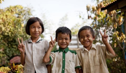 Poe Nay Min, Kali say, Nay Blute Moo (right to left) in front of school after their classes.