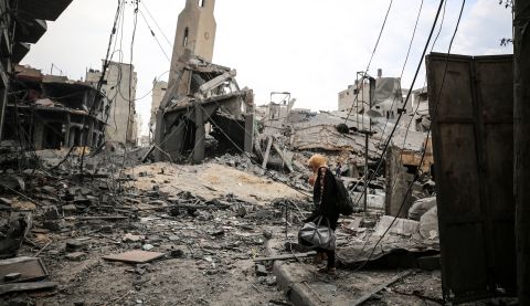 Palestinians inspect a mosque destroyed in strikes on one of Gaza City's refugee camps.