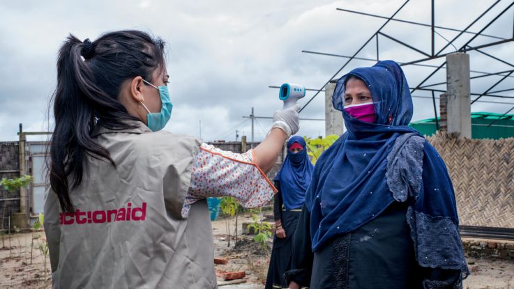 ActionAid worker Uthiya yea Marma is checking Anowara's body temperature before letting her enter inside ActionAid'ss women-friendly space. Cox's Bazar Rohingya Refugee Camp